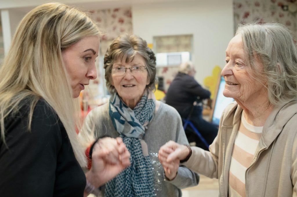 Care home residents chatting and laughing together